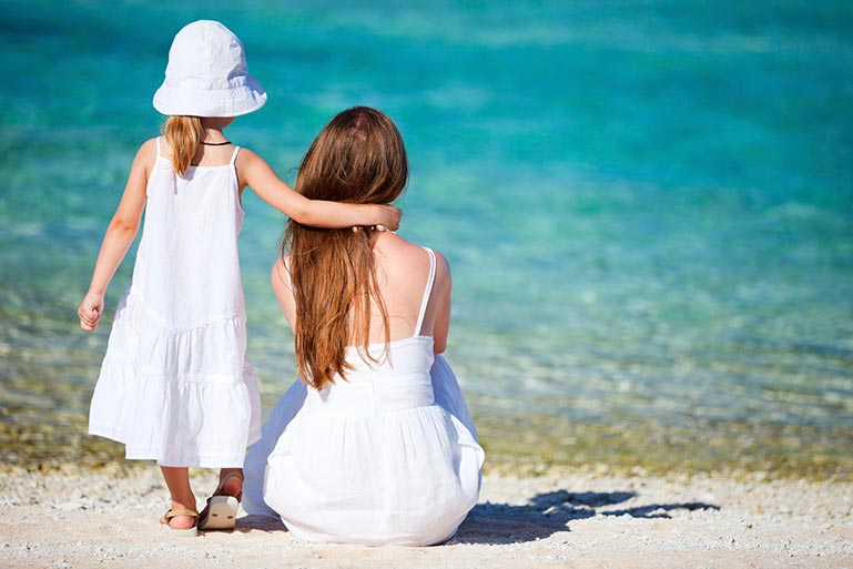 Mother-and-Daughter-sitting-on-the-beach image